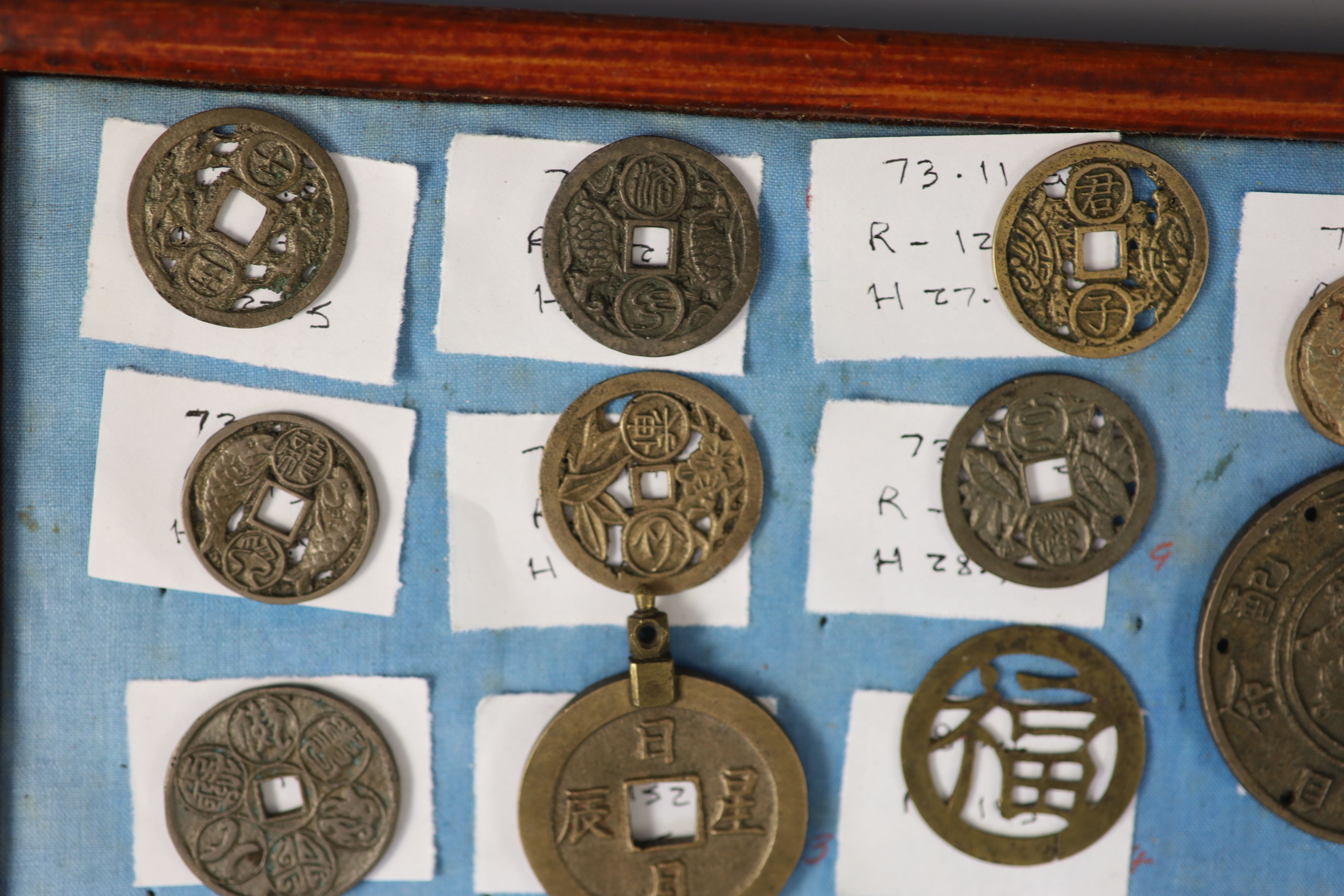 A group of 99 Korean bronze and metal amulets or charms, 19th/20th century